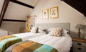 East End Cottage - bedroom two with coombed ceiling and original oak beams