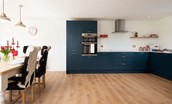 Westwood Cottage - open-plan kitchen/dining space with navy Shaker-style cabinetry