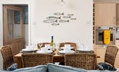 Farne View - dining area with aptly themed mackerel wall art