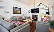 Wild Chive Lodge - the central fireplace with wood burner is at the heart of the open-plan living space