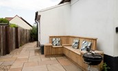 The Tumblers - patio with corner bench seating and barbecue