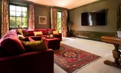 Fairnilee House - cinema room with 86" cinema TV with surround sound and French doors leading to the terrace