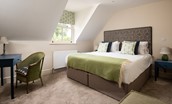 Partridge Lodge - bedroom three with a superking double bed and desk area