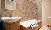The Bothy at Cheswick - bathroom featuring a bath with shower over and large wash hand basin