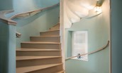 The Tower, Keith Marischal - spiral staircase leading to the first floor, painted a soft aqua