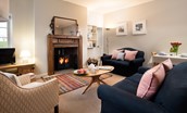 The Bothy at Cheswick - pair of plush, blue sofas and statement armchair provide ample seating in the sitting room