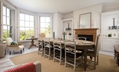 Honeystone House - spacious dining room with a warming open fire and generous south west facing windows with far reaching views