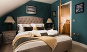 Coach House - bedroom two on the first floor with king size bed, bedside tables and en suite bathroom