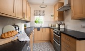 Kilham Cottage - gallery kitchen with double electric oven, four-ring hob, dishwasher and fridge/freezer