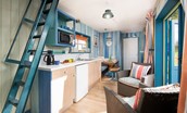 Berrington Beach Hut - living space and kitchen with doors to the deck