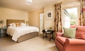Wark Farmhouse - bedroom three with king size bed and armchair