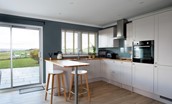 Overthickside - shaker style kitchen with breakfast bar and two stools