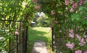 The Showman's Wagon - delightful flowered archway leads into the owners' garden which guests are welcome to use