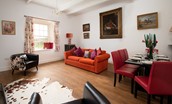Walltown Farm Cottage - sitting room with four-seater sofa, two armchairs and dining table