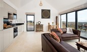The Elm - open plan living room and kitchen with large bi-fold doors leading onto patio