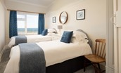 The Fairway - bedroom three with 3' twin beds, chest of drawers, wardrobe and benefiting from sea views