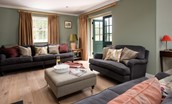 Risingham House - sitting room with patio doors leading outside