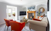 Sea Breeze - sitting room with comfortable seating, Smart TV, wood burner and sun room beyond