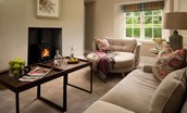 Laurel Cottage - sitting room with large sofa and snuggle seat