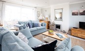 Farne View - light-filled sitting area in the open-plan living space with large sofas
