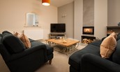 Cambridge House - the sitting room with two large sofas and wood burning stove