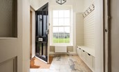 Seaview House - entrance porch / boot room with bench seat and hanging space for outdoor kit