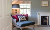 Blackhouse Forest Estate - soft occasional chair and decorative log burner in bedroom three