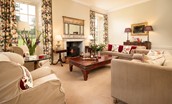 East House - drawing room with wood burning stove, sofas and armchairs