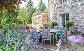 The Old Millhouse - the outside dining area with pretty planting