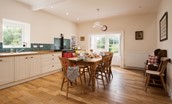 The White House - large open kitchen with dining table and pew bench where guests can socialise together