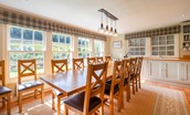 Blackhouse Forest Estate - kitchen dining table set in front of large sash windows is ideal for relaxed dining