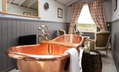 Wagtail - free standing copper bath and armchairs position in front of the large window