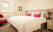 Bamburgh Five - bedroom two with fixed super king size bed, side tables and storage space