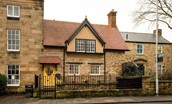 The Woodworker's Cottage - exterior view of property with its vibrant yellow front door