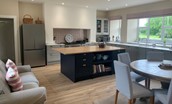 Wark Farmhouse - kitchen with large island, sofa and dining table
