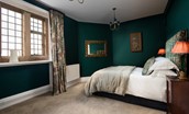The Clock Tower at Bamburgh Castle - bedroom two with castle window and rich heritage colour scheme