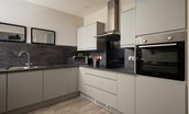 Farm Cottage - the kitchen with sleek grey cabinetry