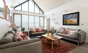 Wild Chive Lodge - the vast contemporary feature windows fill the sitting room with light