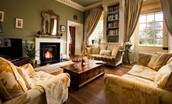Eslington East Wing - ample comfy seating in the drawing room with large 50" TV and open log fire