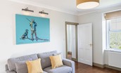 Culdoach Cottage - comfortable seating with bold artwork in the sitting room