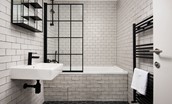 2 The Bay, Coldingham - family bathroom featuring a bath with shower over and stylish monochrome design
