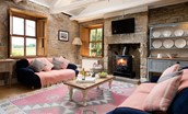 Poppy House - cosy sitting room with wood burning stove