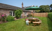 Laurel Cottage - lawned garden with outdoor seating and charcoal barbecue
