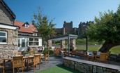 Caste View, Bamburgh - the enclosed garden with plenty of outside seating and stunning views of Bamburgh Castle