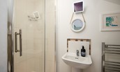 Nook End - ground floor shower room with shower, WC, and basin with illuminated mirror above