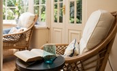 Eslington Lodge - conservatory with comfy seating and views of garden