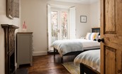 Castle View Cottage - bedroom two is filled with light from the full-height French doors leading into the garden