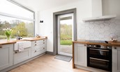 West Mill Cottage - the bright and airy kitchen benefits from a large window and door to the rear garden