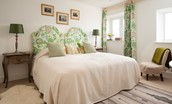 Brunton Lake - bedroom two with zip and link beds, occassional chair and views of the surrounding countryside towards the coast