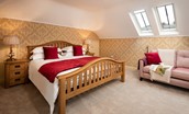 Dryburgh Steading One - bedroom one with super king bed and sofa